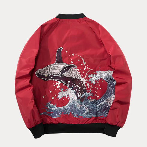 Red embroidered bomber baseball jacket with whale and wave design, featuring stand collar and rib sleeve cuffs.